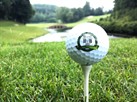 Image: A golf ball with The Cleghorn Club logo sitting on a tee