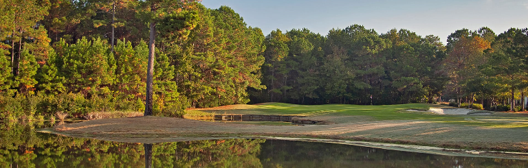 Image: Water in foreground with sand trap guarding the green