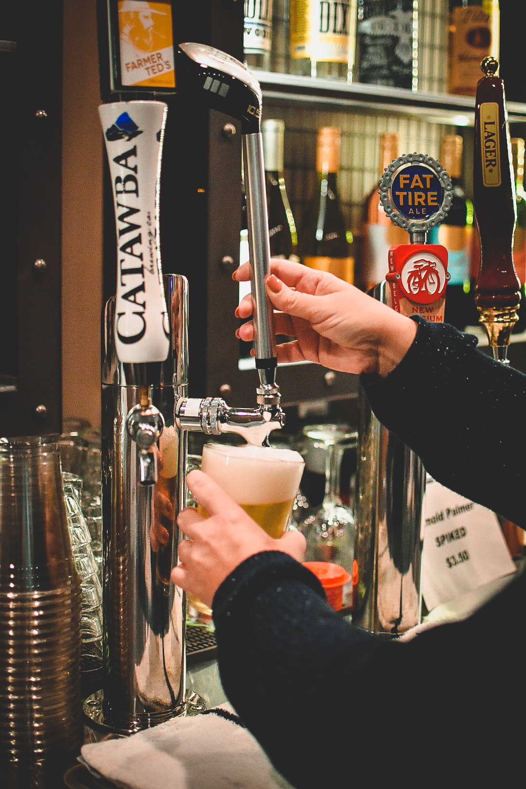 Image: Bartender pouring a draft beer from a tap