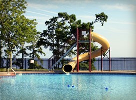 Image: Pool with slide in background